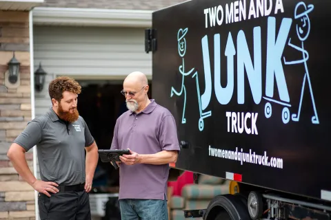 junk hauler finishing junk removal service with happy customer
