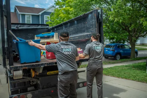Junk haulers removing items before a customers move