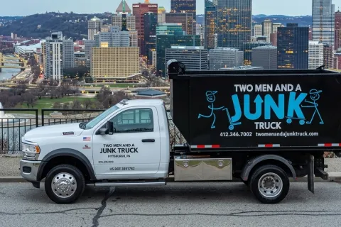 TWO MEN AND A JUNK TRUCK overlooking city of Pittsburgh