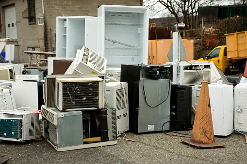 Lots of old refrigerators, microwaves, ovens, dishwashers, washing machines, and dryers taking up space in an outdoor lot