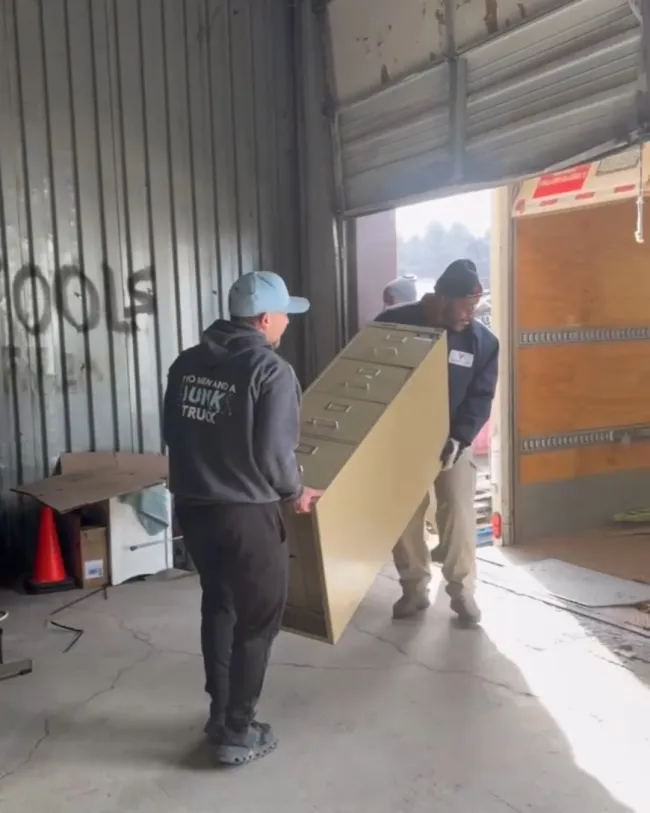 TMJT haulers carrying away a file cabinet