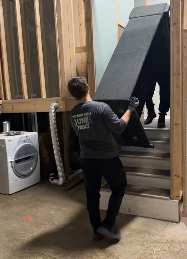 TMJT Haulers carrying away an old desk