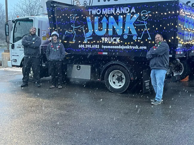 Junk truck in the snow decorated with Christmas lights