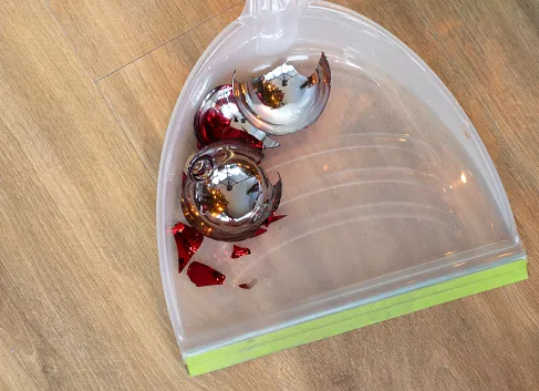 Broken Christmas ornaments being swept up