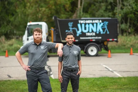 Picture of TWO MEN AND A JUNK TRUCK in front of junk truck