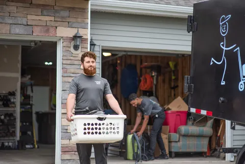 TWO MEN AND A JUNK TRUCK crew removing items from a house, and helping a customer prepare to move
