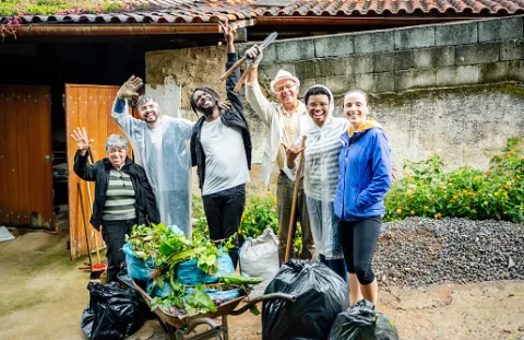A group of people cleaning up an alley in their neighborhood