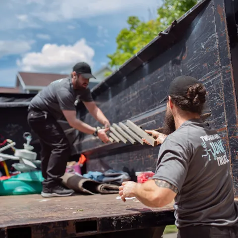 junk-haulers-hauling-junk-onto-a-junk-truck