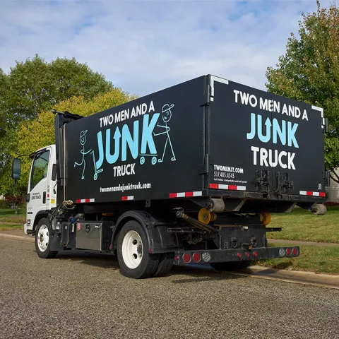junk truck hauling away old junk from a successful junk hauling service