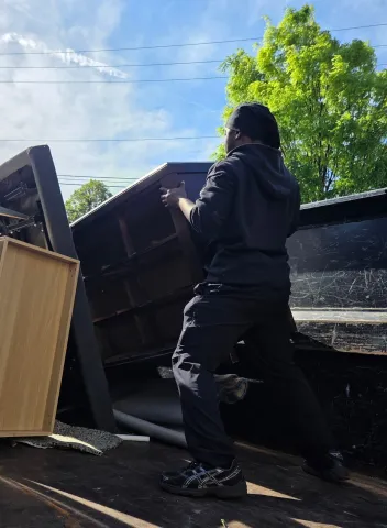 Junk Hauler Loading Furniture into Junk Truck
