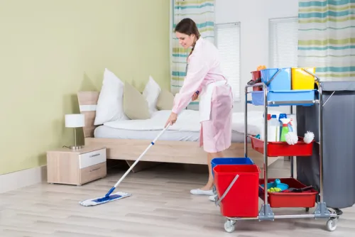 A woman deep cleaning her bedroom