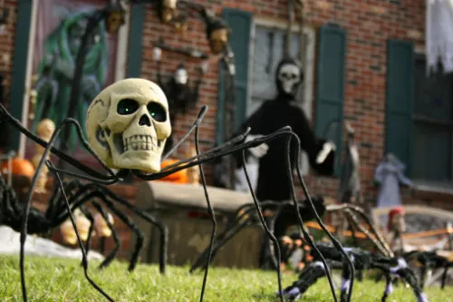 A front lawn and porch covered with spiders and skeletons for Halloween