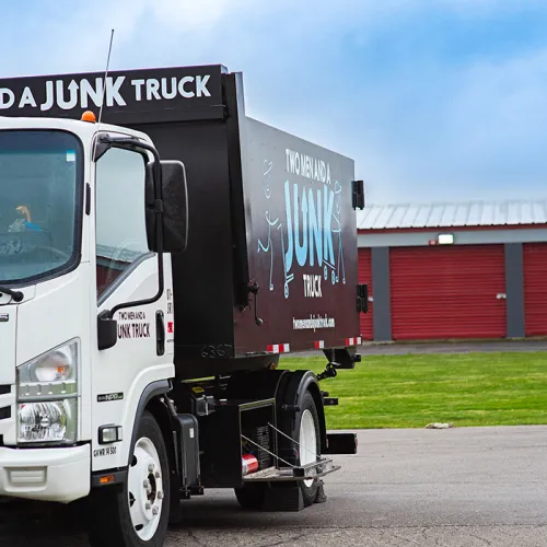 junk removal truck pulling up to a storage unit that needs a haul away service cleanout