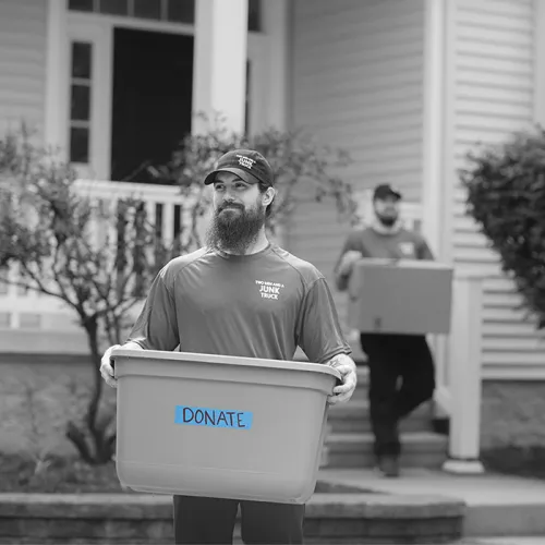 junk hauler leaving customer home with blue donation box
