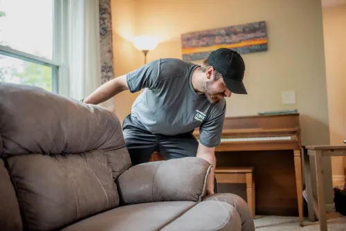 Team Member Picking Up Couch