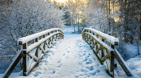 A snowy bridge with footprints