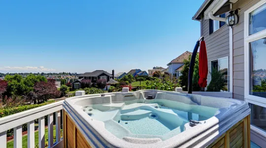 A hot tub that is no longer being used and taking up valuable porch space. It needs to be removed so that the homeowners can better enjoy their view and backyard space