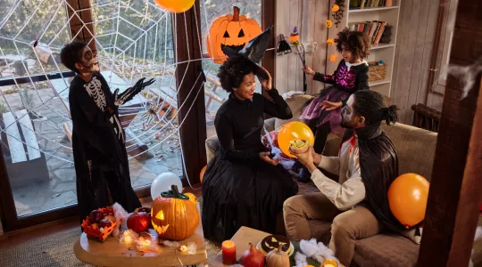family laughing together over their halloween costumes