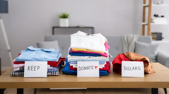 clothes being organized on a table getting ready for declutter