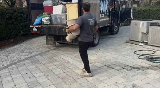 Two Men and a Junk Truck helping a customer haul away items