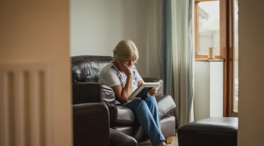 Sad woman holding a sentimental photo in frame