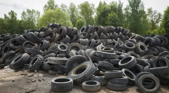 A pile of old tires that have been properly disposed of and are waiting to be broken down and/or recycled