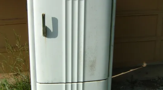 An old refrigerator that is past its prime and needs to be removed to create space for opportunity