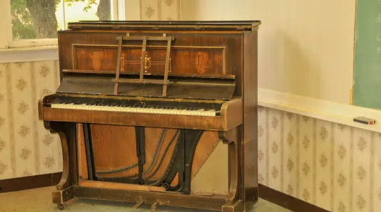 An old and worn down piano that has been well-loved and played by many generations is now ready to be properly and professionally removed