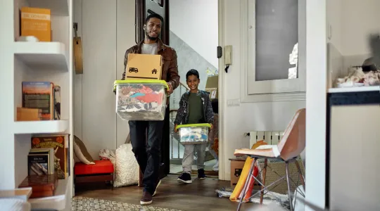 A man and his son cleaning and organizing their home