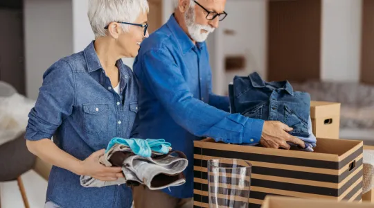 An older married couple taking time to organize and declutter their home