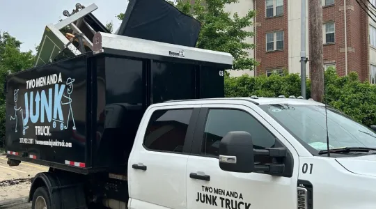 TWO MEN AND A JUNK TRUCK truck full with recyclable goods