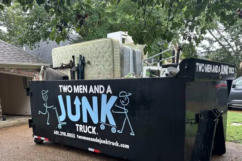 Dumpsters with mattresses in it