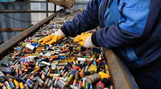 Personal sorts through batteries to recycle